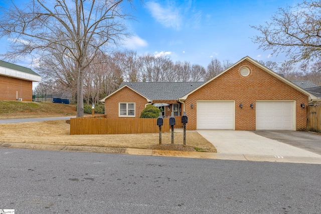 ranch-style house featuring a garage, driveway, brick siding, and a fenced front yard