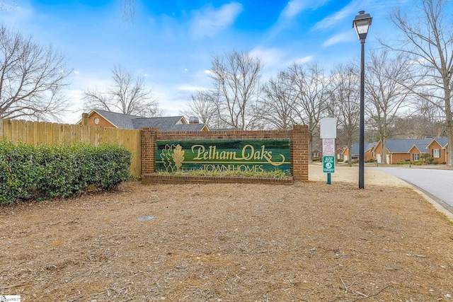 community / neighborhood sign with fence