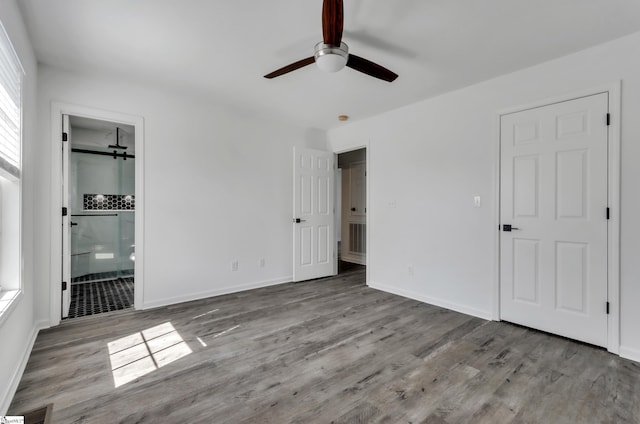 unfurnished bedroom featuring visible vents, wood finished floors, a ceiling fan, and baseboards