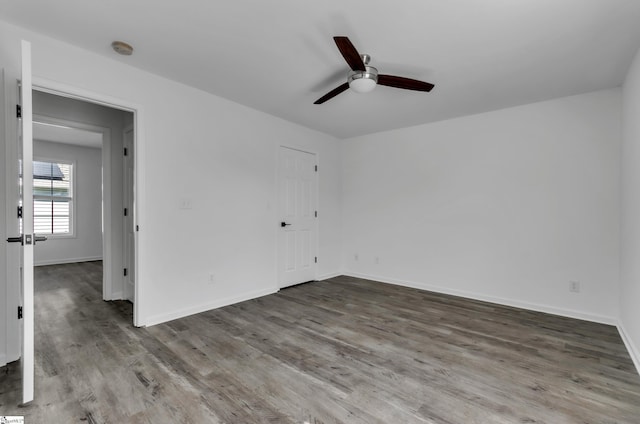 unfurnished bedroom featuring a ceiling fan, baseboards, and wood finished floors