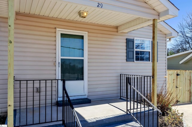 view of exterior entry featuring fence