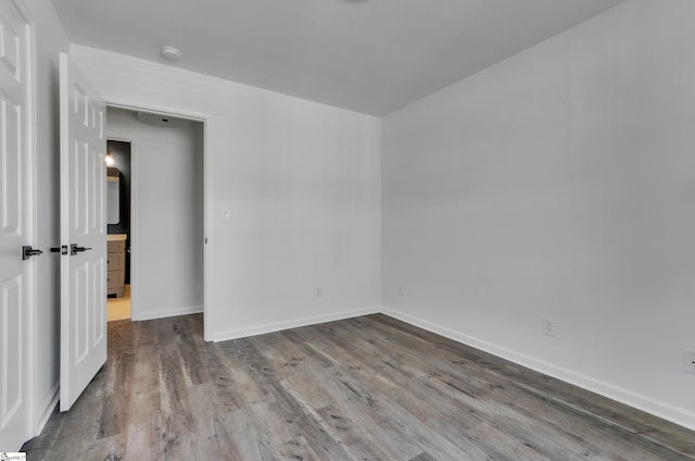 empty room with wood finished floors and baseboards