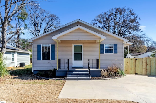 bungalow featuring a porch, a gate, and central AC