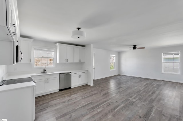 kitchen featuring white cabinets, a wealth of natural light, stainless steel appliances, and a sink