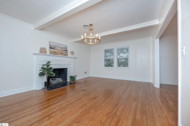 unfurnished living room with beam ceiling, visible vents, light wood-style flooring, a brick fireplace, and a chandelier