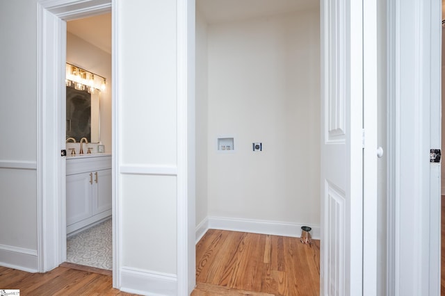 bathroom with vanity, baseboards, and wood finished floors