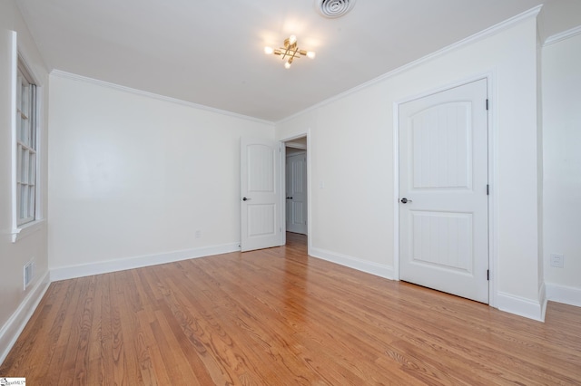 unfurnished bedroom with light wood-style flooring, visible vents, ornamental molding, and baseboards