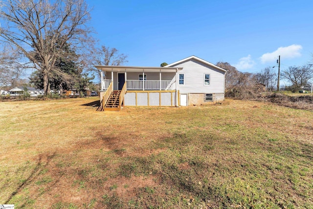 exterior space with stairs, a yard, and a porch