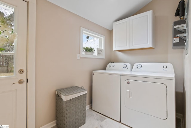 laundry room featuring cabinet space, washing machine and dryer, baseboards, and marble finish floor