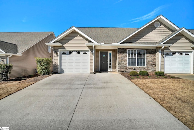 ranch-style home featuring an attached garage, stone siding, driveway, and roof with shingles