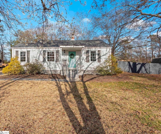 single story home featuring a front yard and fence