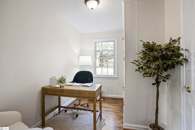 office with baseboards, visible vents, and wood finished floors