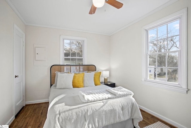 bedroom featuring multiple windows, ornamental molding, and wood finished floors