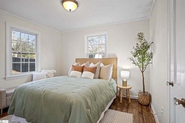 bedroom featuring crown molding, baseboards, and wood finished floors