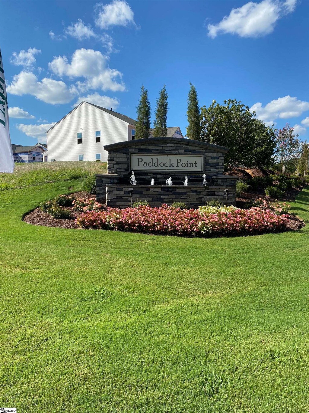 community sign featuring a yard