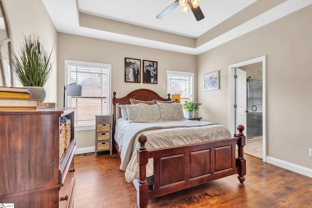 bedroom featuring dark wood-style floors, ceiling fan, and baseboards