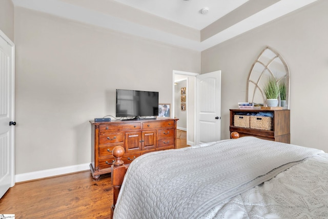 bedroom featuring wood finished floors and baseboards