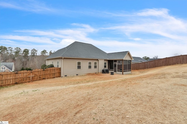 rear view of house featuring a sunroom, fence, and crawl space