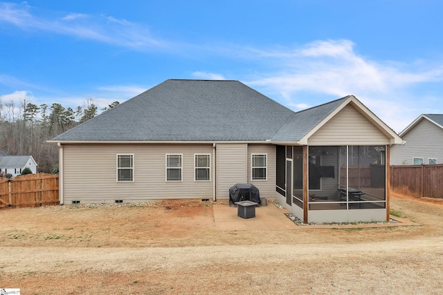 rear view of property with a shingled roof, crawl space, fence, and a sunroom