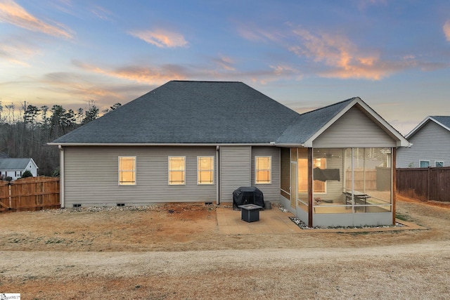 rear view of property featuring crawl space, a sunroom, fence, and roof with shingles