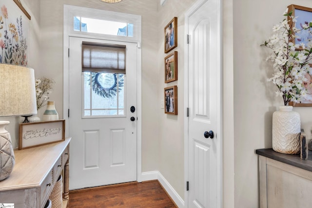 entryway featuring dark wood finished floors and baseboards