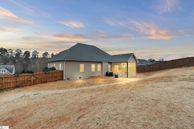 back of house featuring roof with shingles, crawl space, and fence