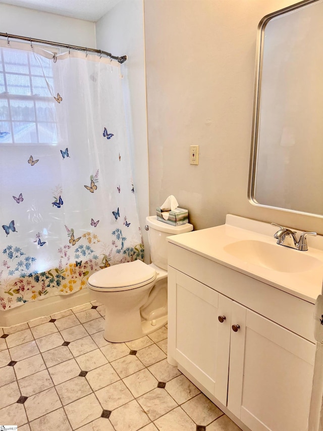 bathroom featuring toilet, shower / bathtub combination with curtain, and vanity