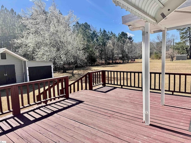 wooden deck featuring a yard