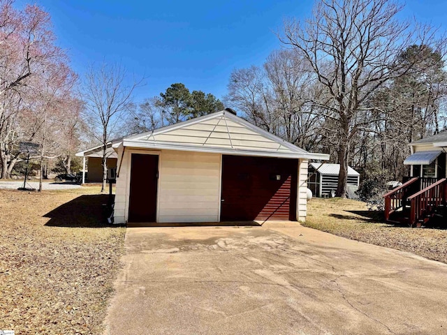 detached garage with concrete driveway