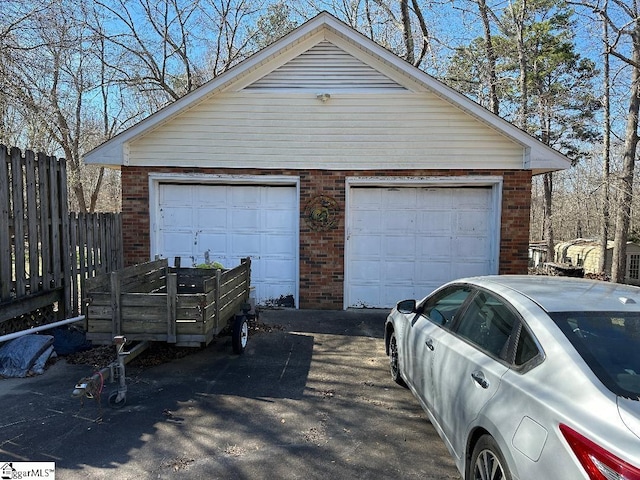 detached garage featuring fence