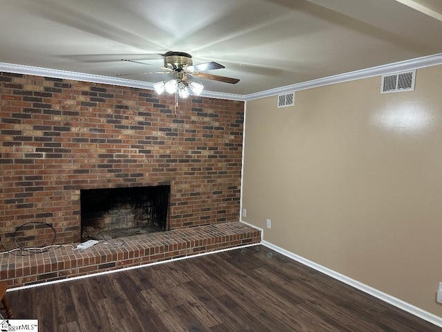 unfurnished living room featuring ornamental molding, dark wood finished floors, and visible vents