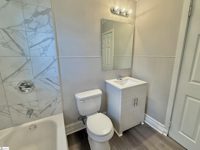 full bathroom with vanity, wood finished floors, toilet, and tile walls