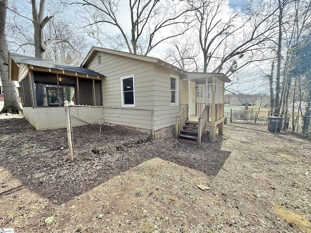 view of side of property with a sunroom