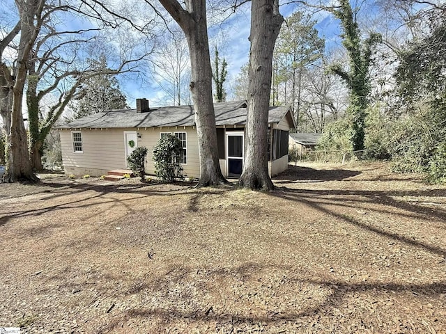 view of front of property with crawl space and a chimney