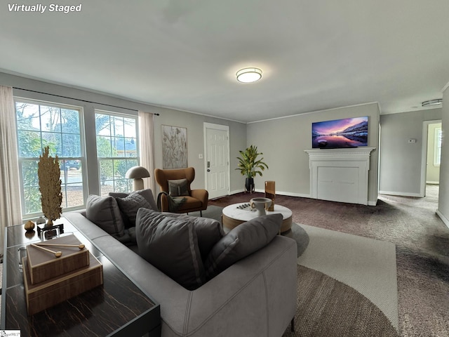 living area with carpet, a fireplace, and baseboards