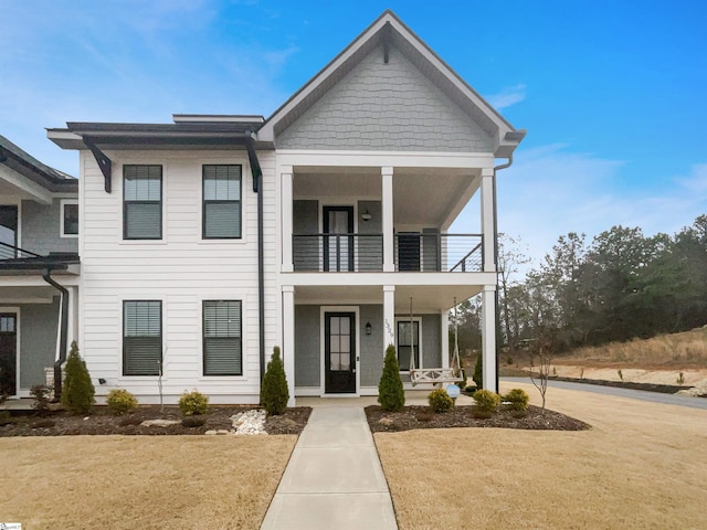 view of front of home featuring covered porch and a balcony