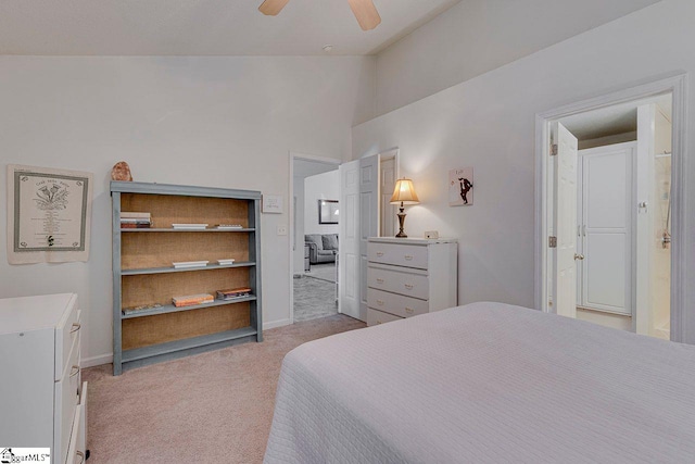 bedroom featuring vaulted ceiling, light colored carpet, ceiling fan, and baseboards