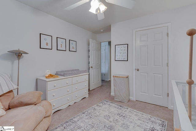 sitting room with a ceiling fan and light colored carpet