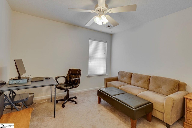 office space featuring ceiling fan, visible vents, baseboards, and carpet flooring