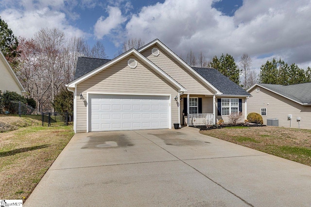 ranch-style home featuring central AC unit, a front yard, fence, a garage, and driveway