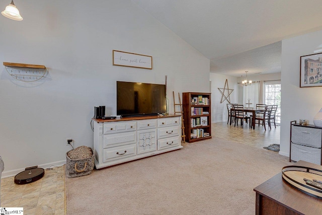 living area with a chandelier, high vaulted ceiling, baseboards, and light colored carpet