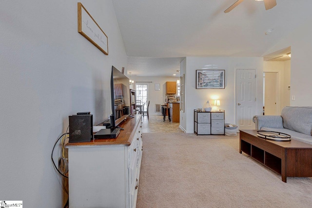 living room featuring a ceiling fan and light colored carpet