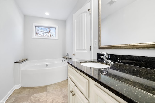 bathroom with a garden tub, recessed lighting, visible vents, vanity, and baseboards