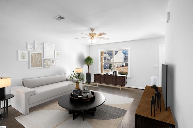 living room featuring visible vents, ceiling fan, and wood finished floors