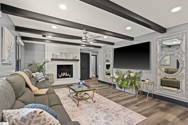 living area with a ceiling fan, a high end fireplace, wood finished floors, and recessed lighting