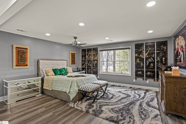 bedroom with baseboards, wood finished floors, visible vents, and recessed lighting