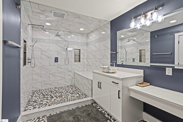 full bathroom featuring visible vents, a stall shower, and vanity