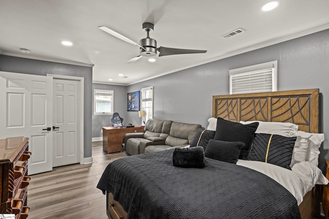 bedroom featuring ornamental molding, wood finished floors, visible vents, and recessed lighting