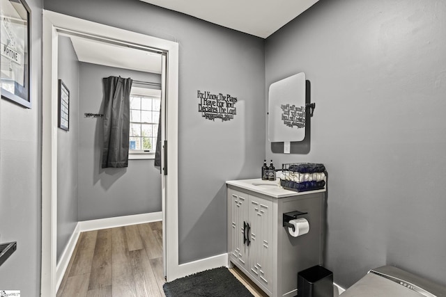 bathroom featuring baseboards and wood finished floors