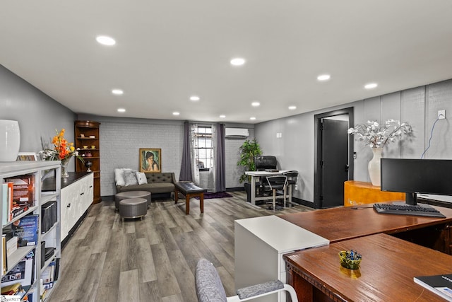 office featuring recessed lighting, a wall mounted AC, and wood finished floors